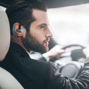 Hombre conduciendo un coche y escuchando música por el auricular